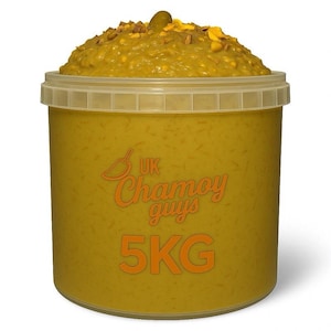 May include: A large, round, yellow plastic container filled with a yellow-orange food product. The container has a clear lid and the text "UK Chamoy guys 5KG" in orange. The food product is topped with a garnish.