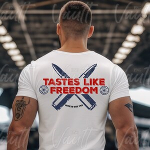 May include: White t-shirt with a red, white, and blue graphic design featuring crossed bullet casings and the text "Tastes Like Freedom" with the words "Defend the 2nd" below.