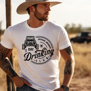 May include: White t-shirt with a black and white graphic of an off-road vehicle and the text "I Day Drinking Club. Official Member."