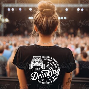 May include: A black t-shirt with a white graphic of a side-by-side vehicle and the text "1 Day Drinking Club Official Member".