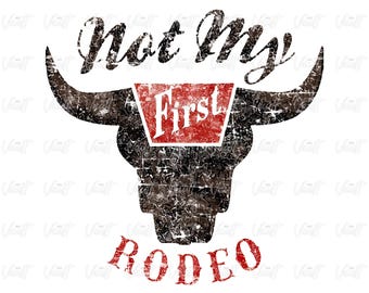 May include: A distressed graphic featuring a bull skull with the text "Not My First Rodeo." The word "First" is in a red rectangle. The design is in black and red on a white background.