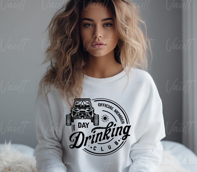 May include: White sweatshirt with a black and white graphic of an off-road vehicle and the text "Official Member 1 Day Drinking Club".