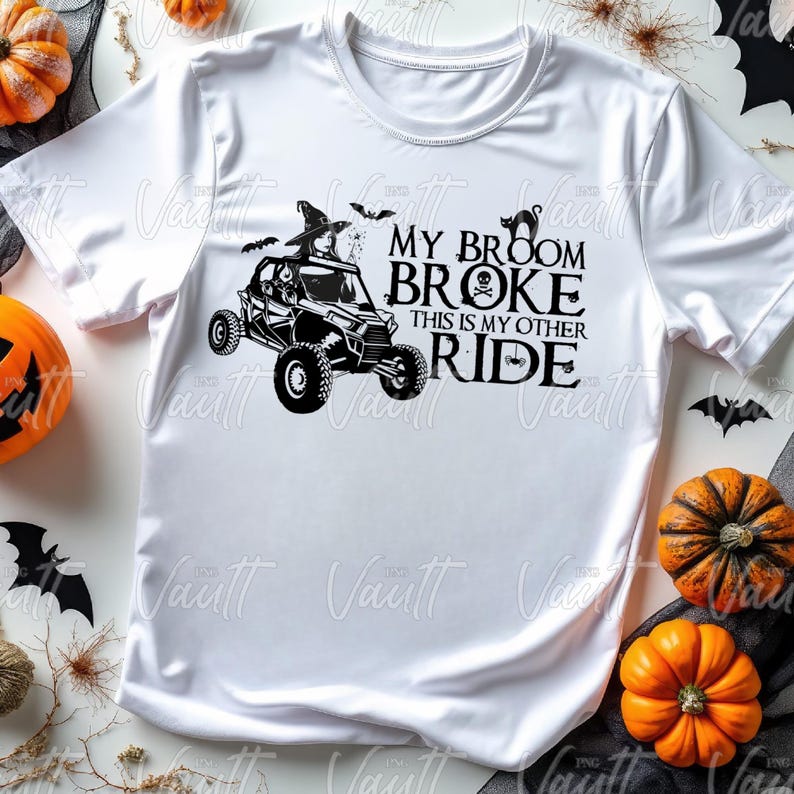 May include: White t-shirt with a black graphic of a Halloween-themed off-road vehicle and the text "My broom broke, this is my other ride."