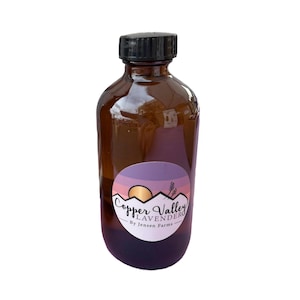 May include: A brown glass bottle with a black lid and a purple and pink label that says "Copper Valley Lavender" and "By Jensen Farms".