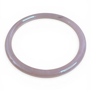 May include: A light pink bangle bracelet. The circular bracelet is a solid color with a glossy finish. The bracelet is a simple, elegant design, suitable for everyday wear. The bracelet is made of a solid material.