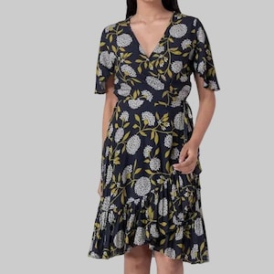 May include: A navy blue wrap dress with a floral pattern. The dress features white and yellow floral designs, short sleeves, and a ruffled hem. The dress has a V-neckline and a wrap-around style.