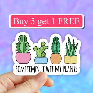 May include: A white sticker with a pink banner that says "Buy 5 get 1 FREE". Below the banner are four potted plants: a cactus in a pink pot, a cactus in a blue pot, a cactus in an orange pot, and a succulent in a yellow pot. The sticker says "Sometimes, I wet my plants".