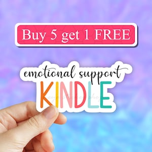 May include: A sticker with the text "emotional support KINDLE" in rainbow colors. The sticker has a white border and is held by a hand. The text "Buy 5 get 1 FREE" is on a pink banner above the sticker.