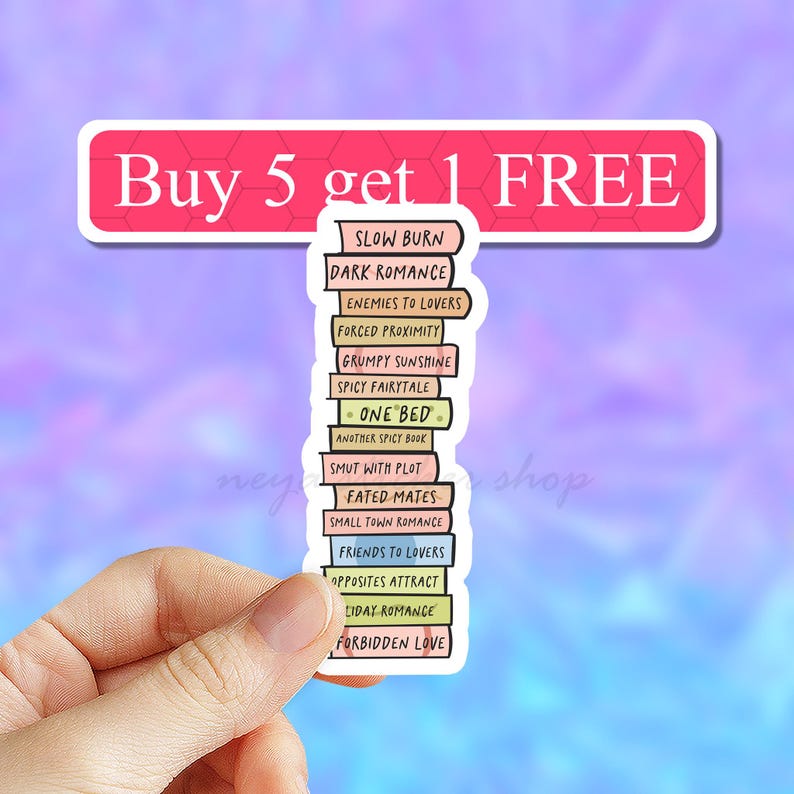 May include: A sticker with a stack of books with different romance novel titles. The sticker says "Buy 5 get 1 FREE" at the top. The book titles include "Slow Burn", "Dark Romance", "Enemies to Lovers", "Forced Proximity", "Grumpy Sunshine", "Spicy Fairytale", "One Bed", "Smut with Plot", "Fated Mates", "Friends to Lovers", "Opposites Attract", "Holiday Romance", and "Forbidden Love".