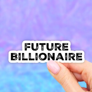 May include: White sticker with black text that reads "FUTURE BILLIONAIRE".