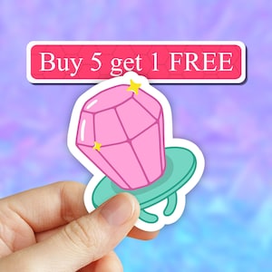May include: Pink diamond ring sticker with a turquoise ring and gold stars. The sticker says "Buy 5 get 1 FREE".