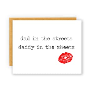 May include: A white card with black text that reads "dad in the streets daddy in the sheets" with a red lipstick kiss mark at the bottom.