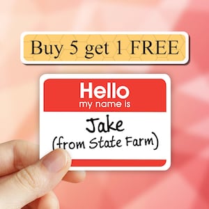 May include: A red name tag with the text "Hello my name is Jake (from State Farm)". The name tag is being held by a hand. The background is a blurry orange and yellow pattern.