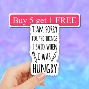May include: White sticker with black text that reads "I am sorry for the things I said when I was hungry" with a fork and knife graphic. The sticker has a pink and white background.