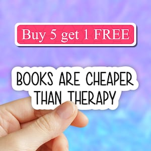 May include: White sticker with the text "BOOKS ARE CHEAPER THAN THERAPY" in black lettering. A smaller pink sticker above reads "Buy 5 get 1 FREE".