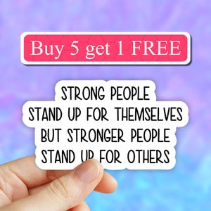 May include: White sticker with black text that reads "Strong people stand up for themselves but stronger people stand up for others".