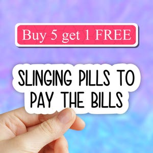 May include: White sticker with black text that reads "SLINGING PILLS TO PAY THE BILLS". A pink banner above the sticker reads "Buy 5 get 1 FREE".