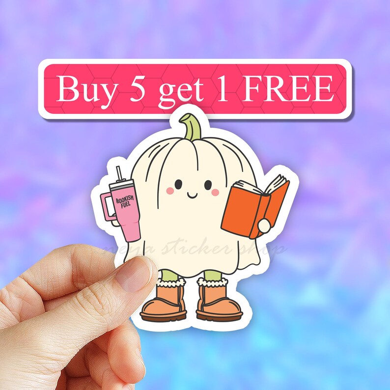 May include: A white ghost-shaped sticker with a smiling face, holding a pink tumbler that says "BOOKISH FUEL" and an orange book. The sticker also has a pink banner that says "Buy 5 get 1 FREE".