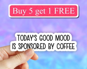 May include: White sticker with the text "TODAY'S GOOD MOOD IS SPONSORED BY COFFEE" on a pink and blue background. A pink sticker with the text "Buy 5 get 1 FREE" is above the white sticker.