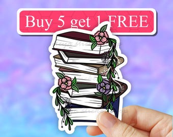 May include: A sticker featuring a stack of books with flowers and vines. The sticker has the text "Buy 5 get 1 FREE" at the top.