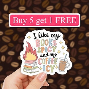 May include: A sticker with a colorful illustration of a stack of books on fire, a cup of coffee with a straw, and the text "I like my BOOKS SPICY and my COFFEE ICY". The sticker also has a pink banner at the top that says "Buy 5 get 1 FREE".