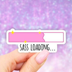 May include: Pink and white loading bar sticker with the text "SASS LOADING..." in black. The loading bar is partially filled with pink and has two yellow stars on top.