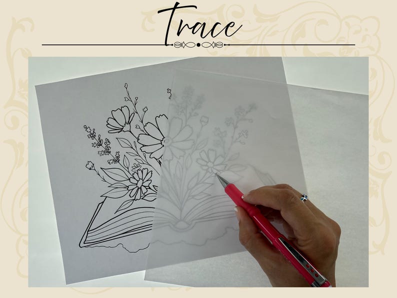 May include: A sheet of white paper with a black line drawing of a book and flowers, partially covered by a translucent sheet of tracing paper. A pink mechanical pencil is used to trace the floral design onto the semi-transparent overlay.