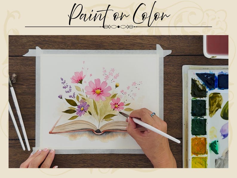 May include: A watercolor painting on paper featuring an open book with pink and purple flowers emerging from the pages. The artwork includes green leaves and delicate floral stems. A paintbrush is held near the paper, with a paint palette nearby.