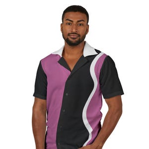 May include: A short-sleeve button-down shirt featuring a color-blocked design with a white collar, a solid mauve panel on the left, and a black panel on the right separated by a white wavy line. The shirt has a classic camp collar and black buttons.
