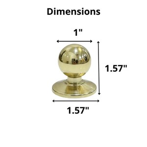 K&ouml;nnte beinhalten: Ein goldfarbener Schrankknopf mit kugelf&ouml;rmiger Oberseite und kreisf&ouml;rmiger Basis. Der Knopf ist 2,54 cm breit und 4 cm hoch. Das Wort "Dimensions" ist &uuml;ber dem Knopf aufgedruckt.