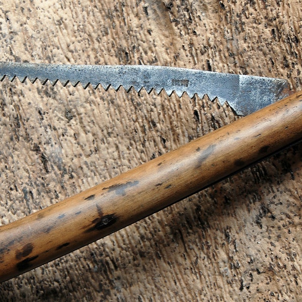 Old gardener's folding saw, wooden handle