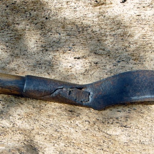 Antique cleaver knife made of forged steel and wooden handle.