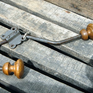 Old vintage metal and wood coat rack with its clip. image 1