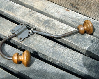 Old vintage metal and wood coat rack with its clip.