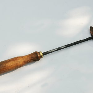 Old copper soldering iron, wooden handle.