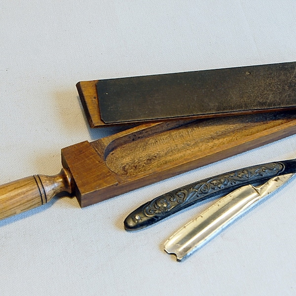 Vintage straight razor and its wooden case.