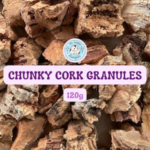 May include: A close-up image displays chunky cork granules, a natural substrate for small pets. The granules are various shades of brown and tan. The text "CHUNKY CORK GRANULES" is on a pink banner, with "120g" below.