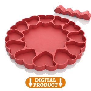 May include: A red silicone mold for making heart-shaped treats. The mold is shaped like a circle with 12 heart-shaped cavities. There is a separate piece of silicone that is shaped like a wavy line.  The mold is a digital download.