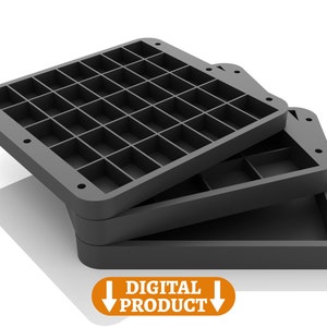 May include: Three black plastic trays with a grid pattern of square compartments. The trays are stacked on top of each other.