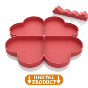 May include: A red silicone mold shaped like a four-leaf clover with each leaf shaped like a heart. The mold is designed for making four heart-shaped treats.