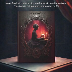 Op de afbeelding: Een boek met een donkere, gotische omslag met een silhouet van een vrouw, een kristallen bol en een kaars. De omslag heeft een decoratief frame en de woorden "Personalized Text" bovenaan. Het product bestaat uit gedrukt artwork op een plat oppervlak.
