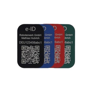May include: Four e-ID tags with a black and white QR code, the text "e-ID", "Roboterwerk GmbH", "Mathias Hubrich", and "DEU123456abc1" in white, and the text "GmbH ibrich" in white. The tags are black, blue, red, and green.