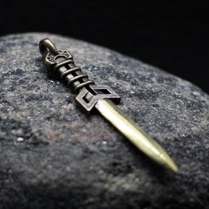 Stylized scythian akinak sword jewelry pendant. Ancient world Scythians sword. Amulet of warrior. Ancient rome. Horseman. Akinak pendant