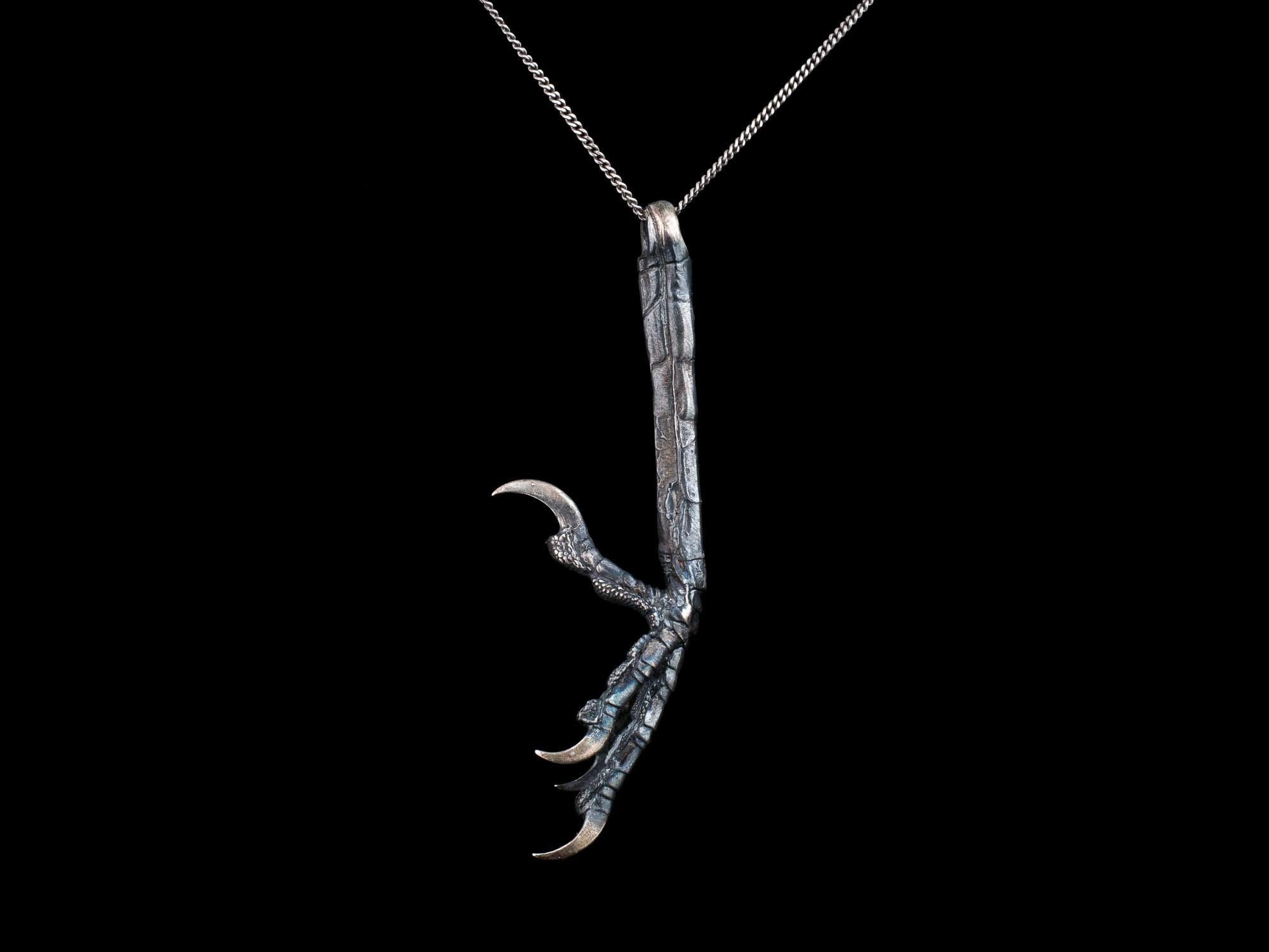 Crow claw jewelry pendant. Raven crow magic talisman claws. North europe tradition. Real like metall crow raven jewelry pendant dinosaur