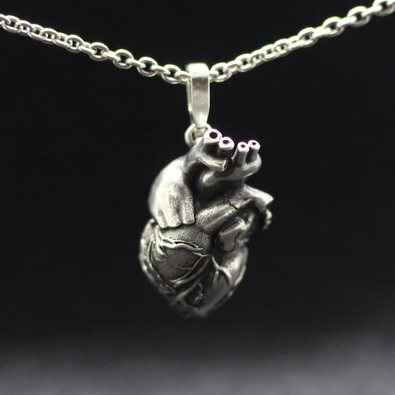 Anatomical human heart jewelry pendant. All-metall anatomical heart. Detailed highly anatomical. Heart valves anatomy. Love symbol romantic