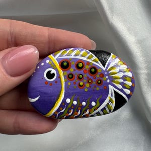 Hand painted stone Funny Fish. Original acrylic painting on the stone. Hand-painted small rock. Happy fish painting on the stone.