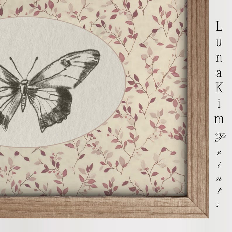 May include: A framed print with a delicate butterfly illustration in a white oval on a background of pink and cream floral pattern.