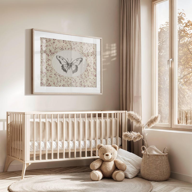 May include: A white crib with a white mattress and a white teddy bear sitting on a rug in front of it. There is a framed print of a butterfly on the wall behind the crib.