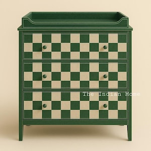 May include: A green three-drawer chest of drawers with a checkered pattern in green and beige. The chest has a changing table top and round knobs.