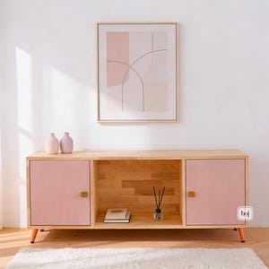 Aura pink media console with fluted doors, gold knobs, and open shelf storage